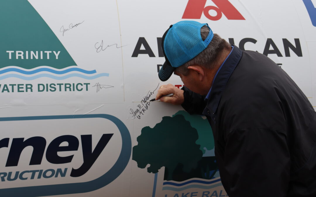 Upper Trinity director Larry Patterson signs commemorative last piece of pipe on February 2025